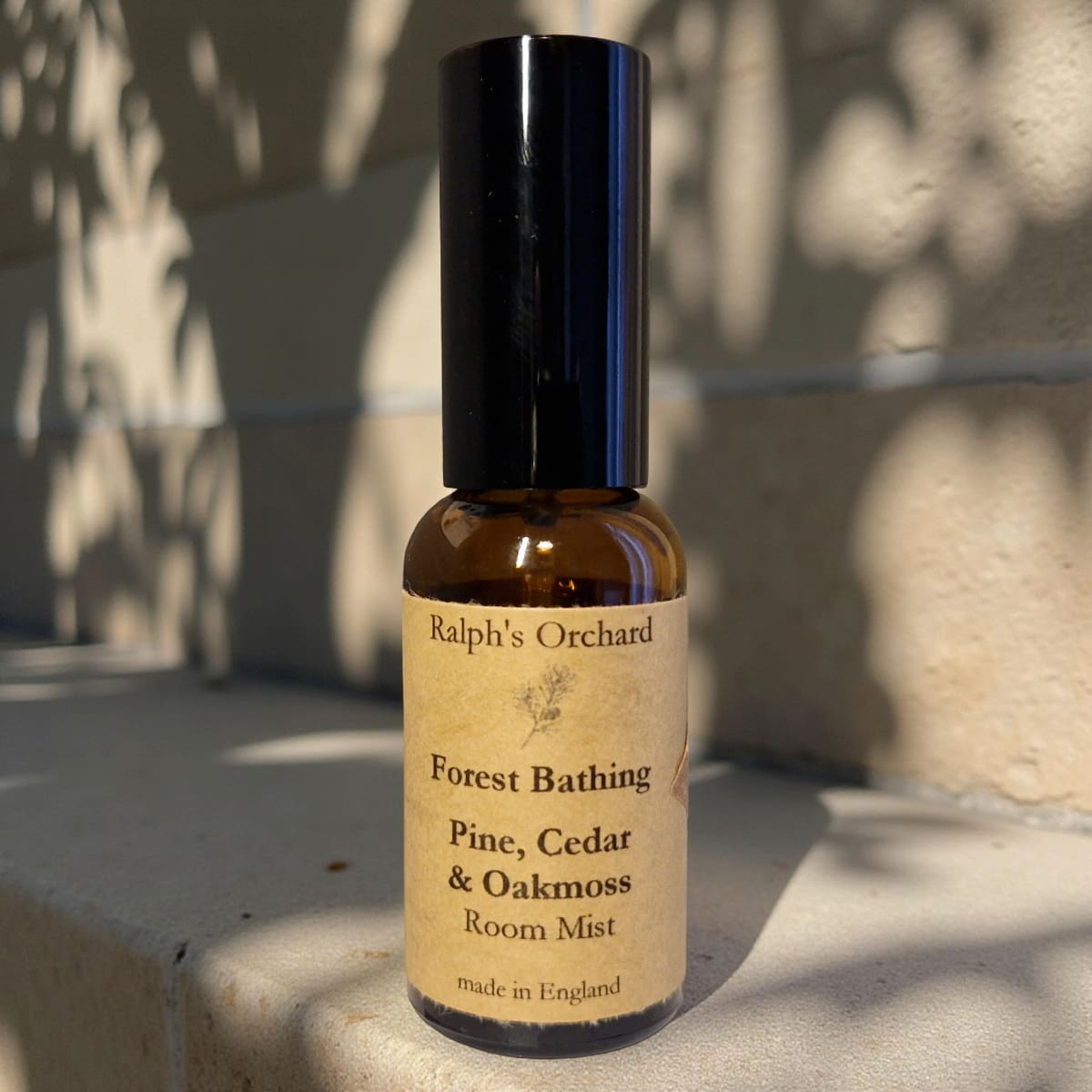 Bottle of 'Forest Bathing' room mist by Ralph's Orchard on a stone surface.