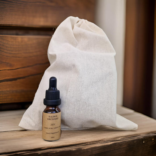 Bottle of 'Ralph's Orchard Zen' on a wooden surface with a white drawstring bag in the background.