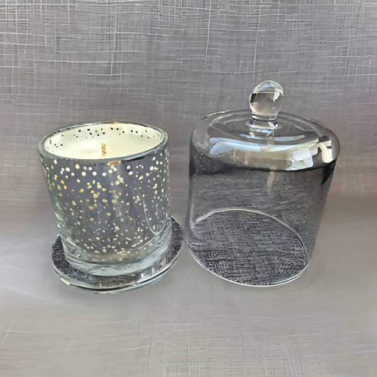 Glass candle holder with a lid on a textured surface
