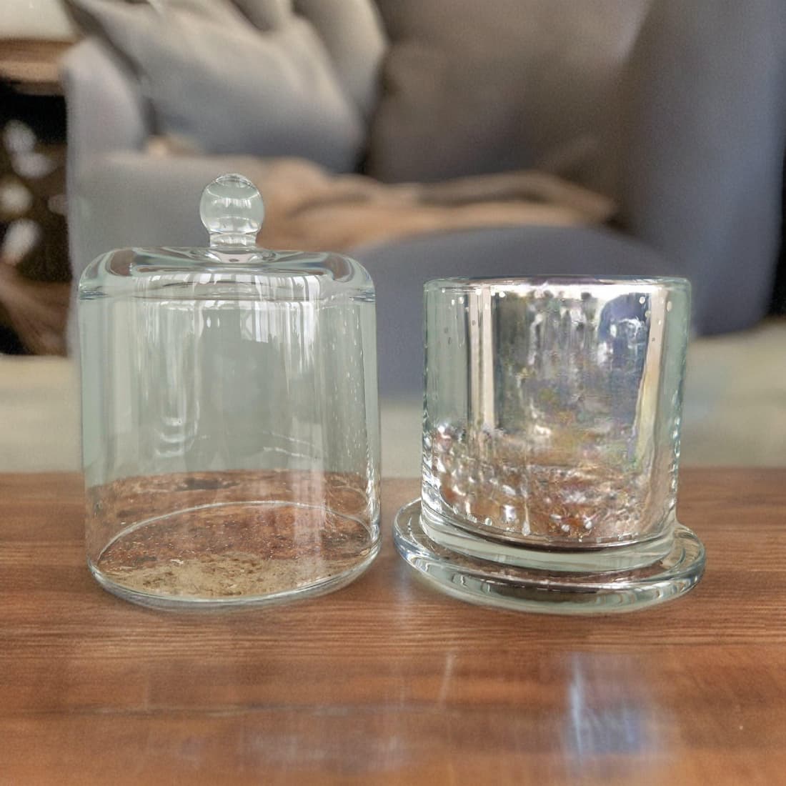 Two glass containers on a wooden surface with a blurred background