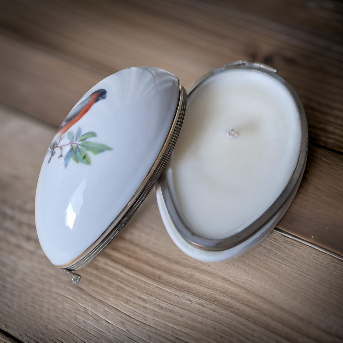 Decorative ceramic container with lid on a wooden surface