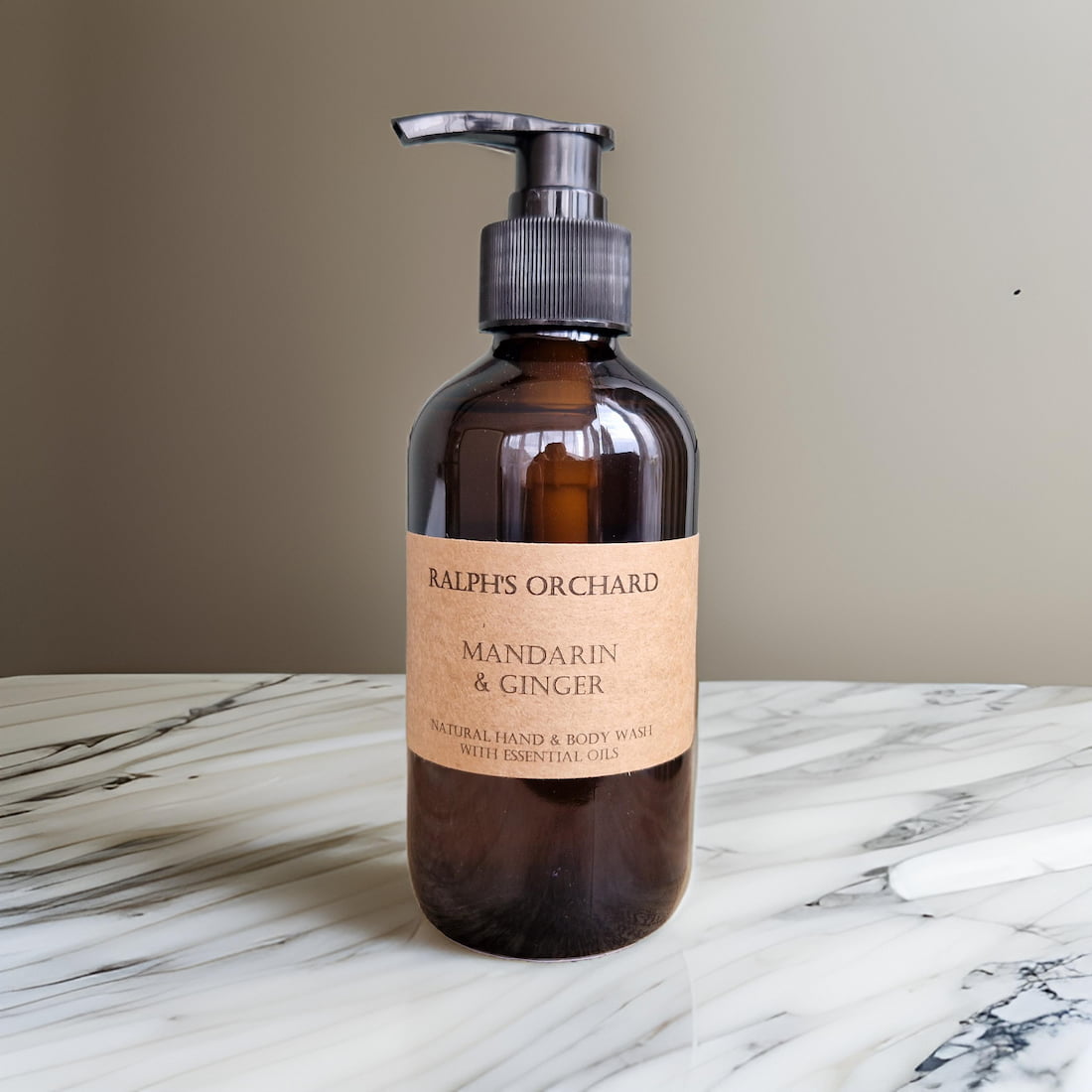 Bottle of Ralph's Orchard Mandarin & Ginger hand and body wash on a marble surface.