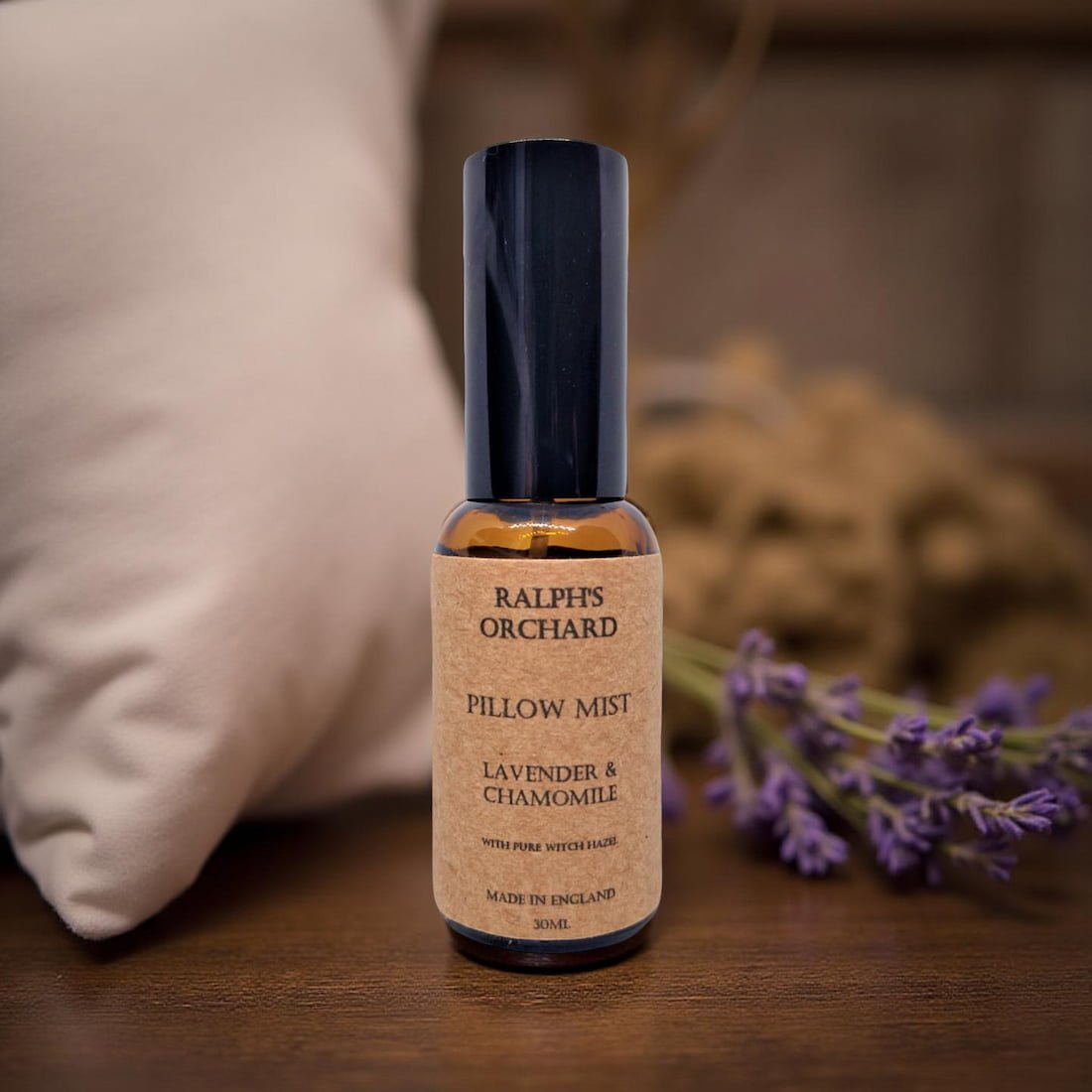 Bottle of Ralph's Orchard Pillow Mist with lavender and chamomile on a wooden surface.