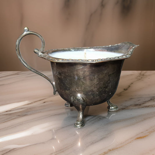 Silver gravy boat on a marble surface