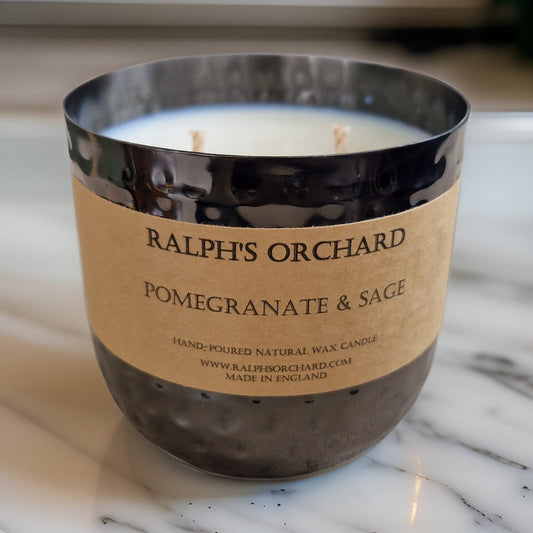 Candle with 'Ralph's Orchard' label on a marble surface