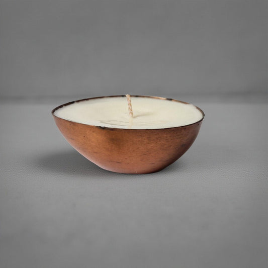 Ceramic bowl with a candle inside on a gray background