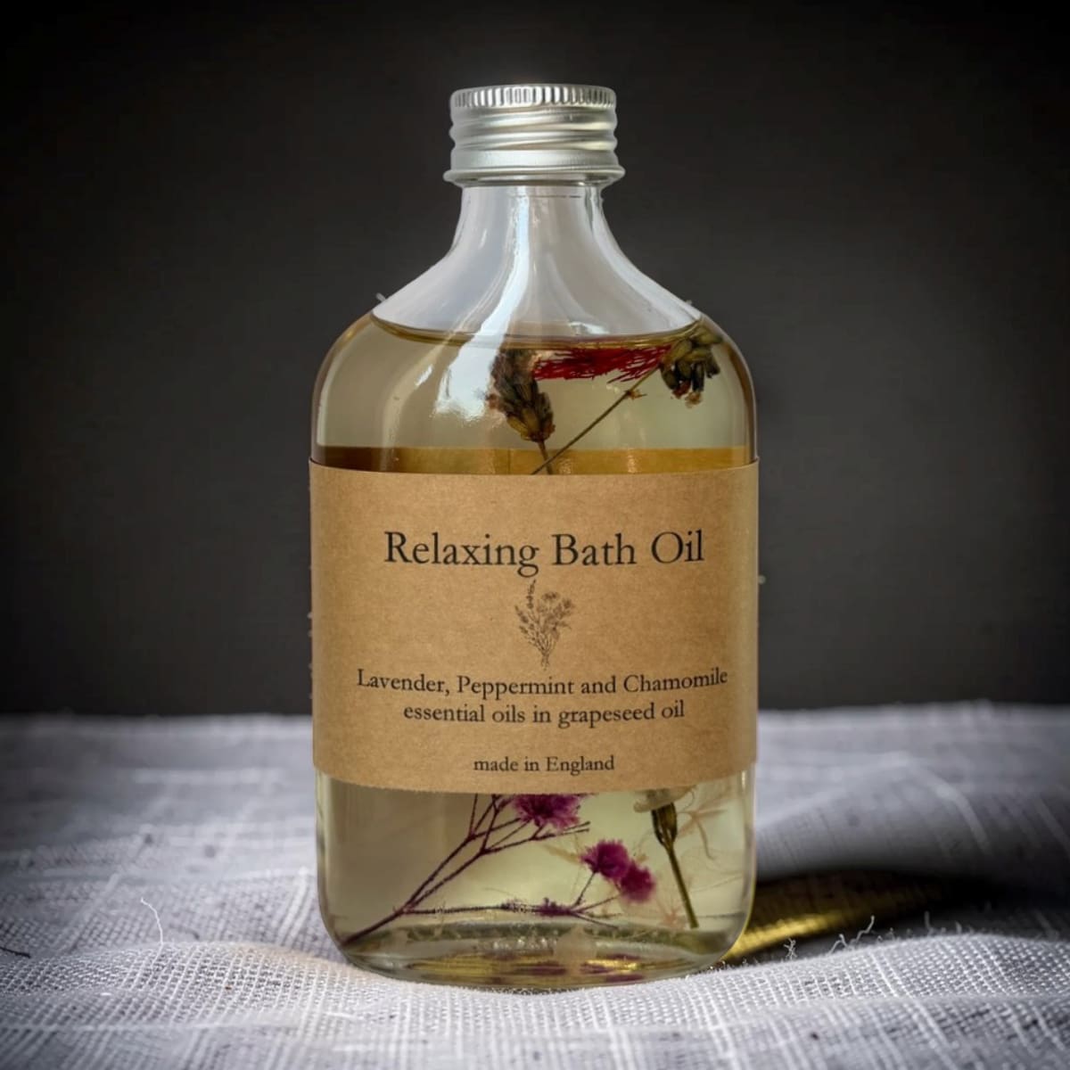 Bottle of Relaxing Bath Oil with a label on a dark background