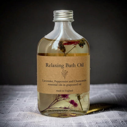 Bottle of Relaxing Bath Oil with a label on a dark background
