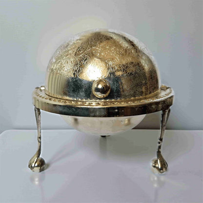 Decorative object with gold dome and silver base on a white background