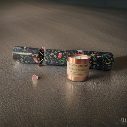 Candle with floral cracker on a textured surface