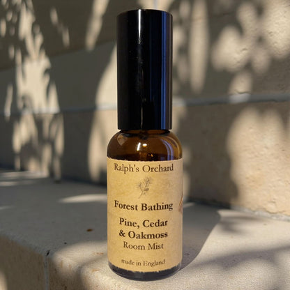 Bottle of 'Forest Bathing' room mist by Ralph's Orchard on a stone surface.