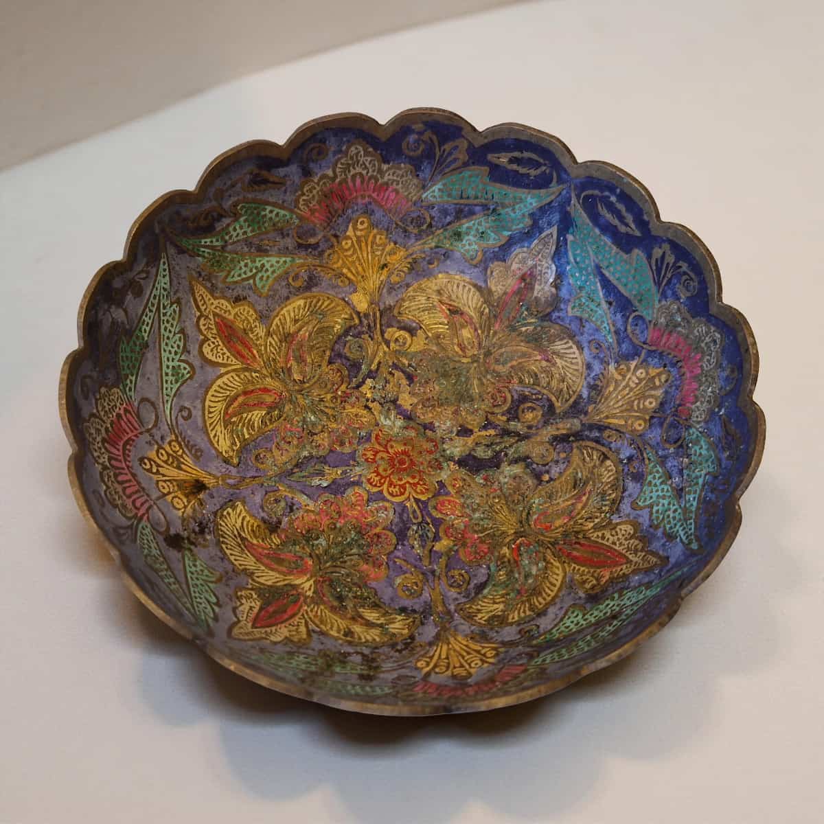 Decorative bowl with intricate floral patterns on a white background