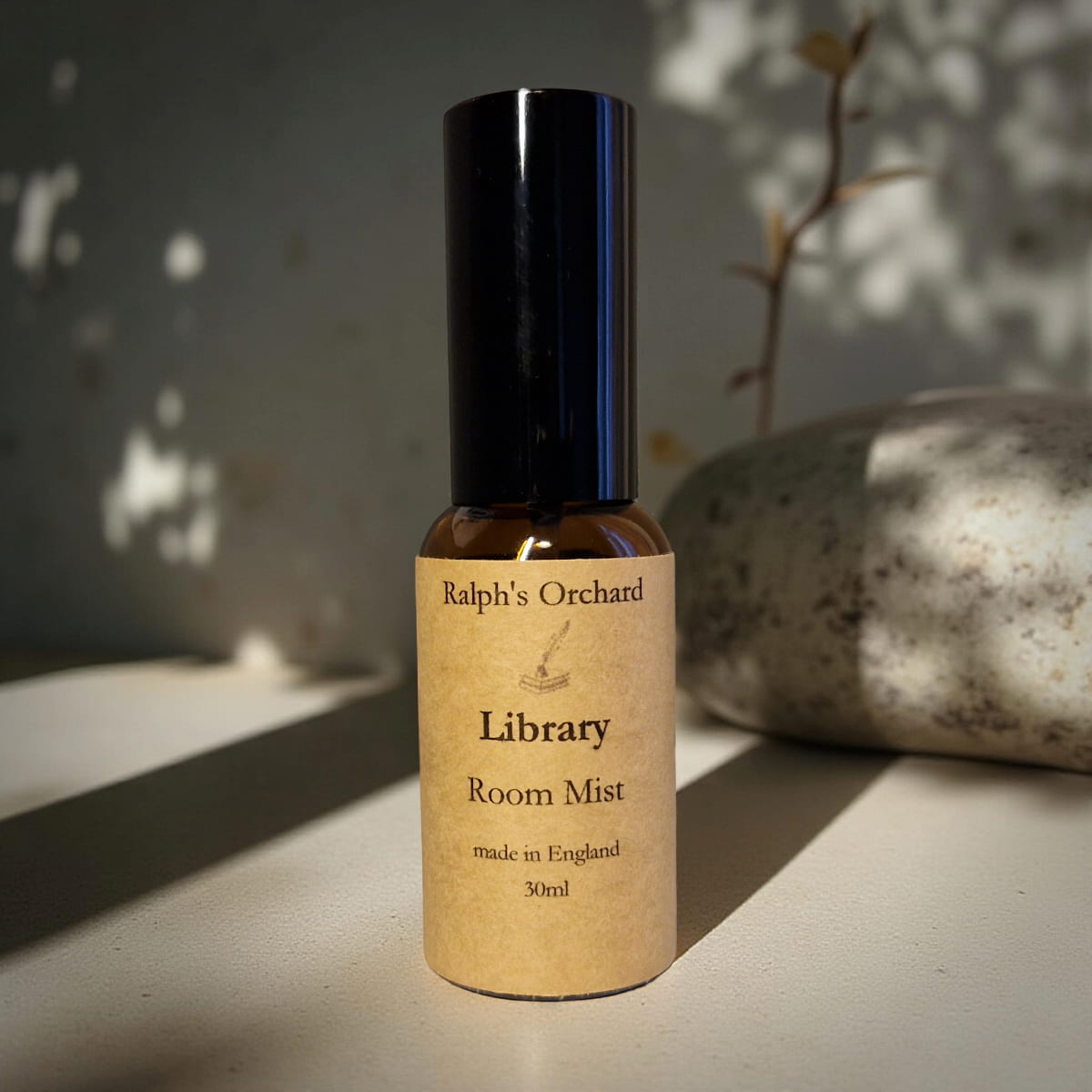 Bottle of Ralph's Orchard Library Room Mist on a textured surface with a natural background