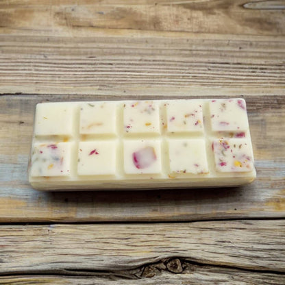 Bar of soap with visible ingredients on a wooden surface