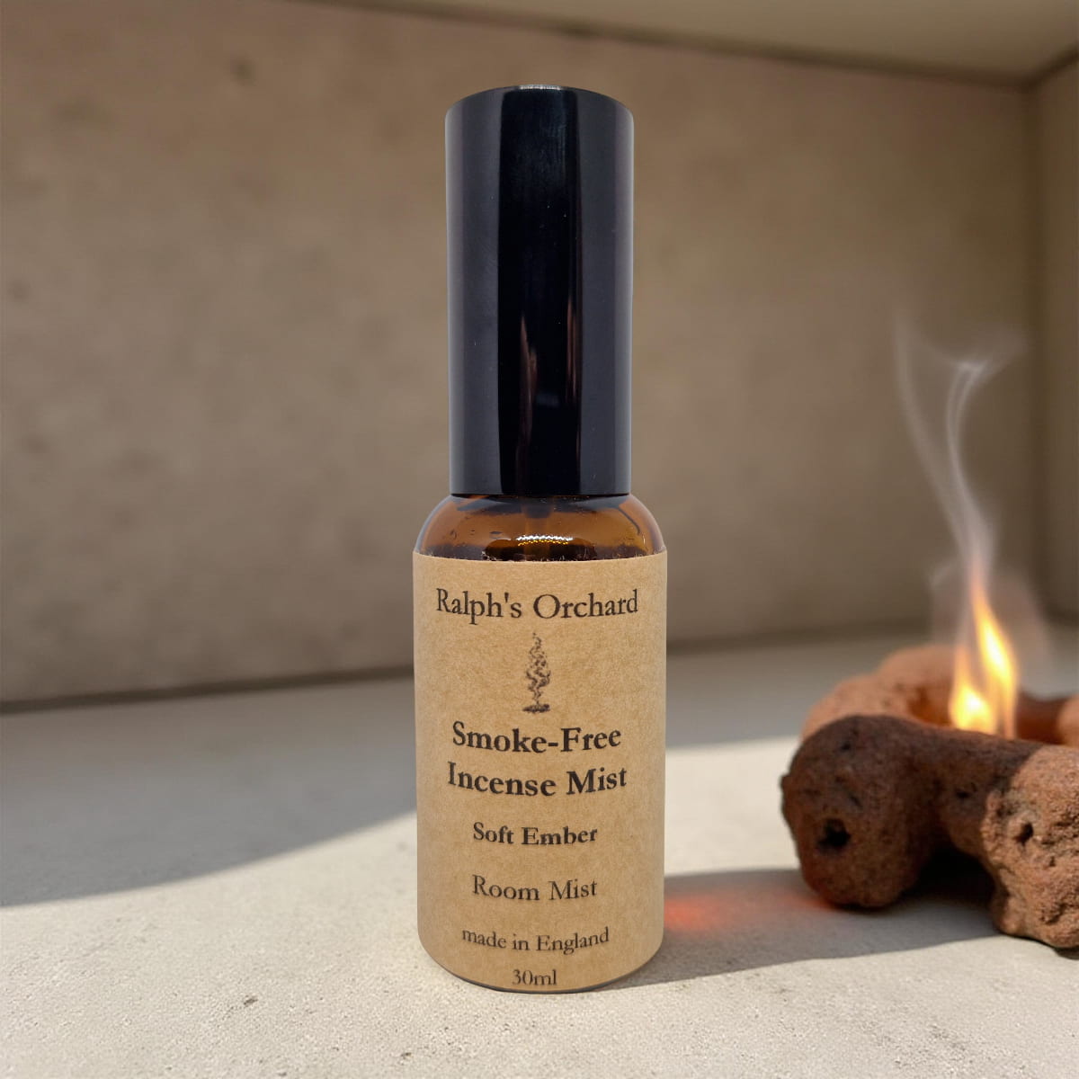 Bottle of Ralph's Orchard Smoke-Free Incense Mist on a neutral background with incense cones.