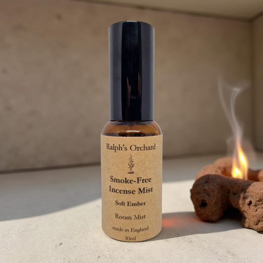 Bottle of Ralph's Orchard Smoke-Free Incense Mist on a neutral background with incense cones.