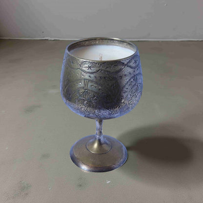 Decorative silver goblet on a gray surface