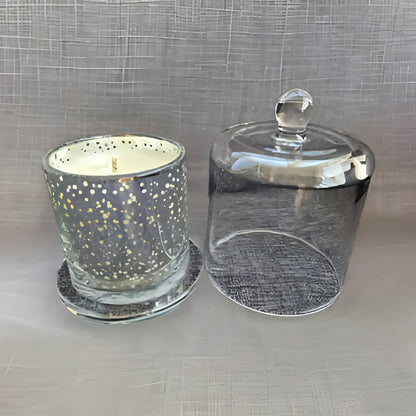 Glass candle holder with a lid on a textured surface