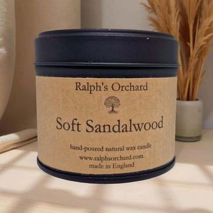 Candle labeled 'Ralph's Orchard Soft Sandalwood' on a neutral background