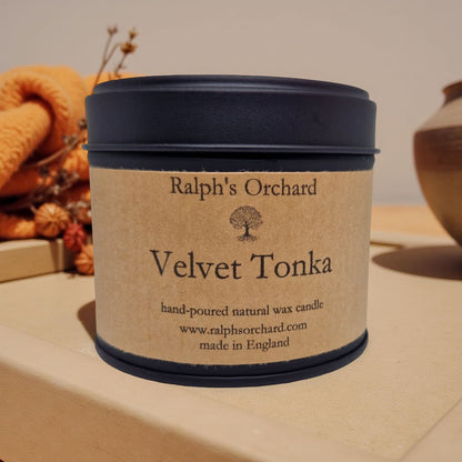 Candle labeled 'Velvet Tonka' from 'Ralph's Orchard' on a neutral background