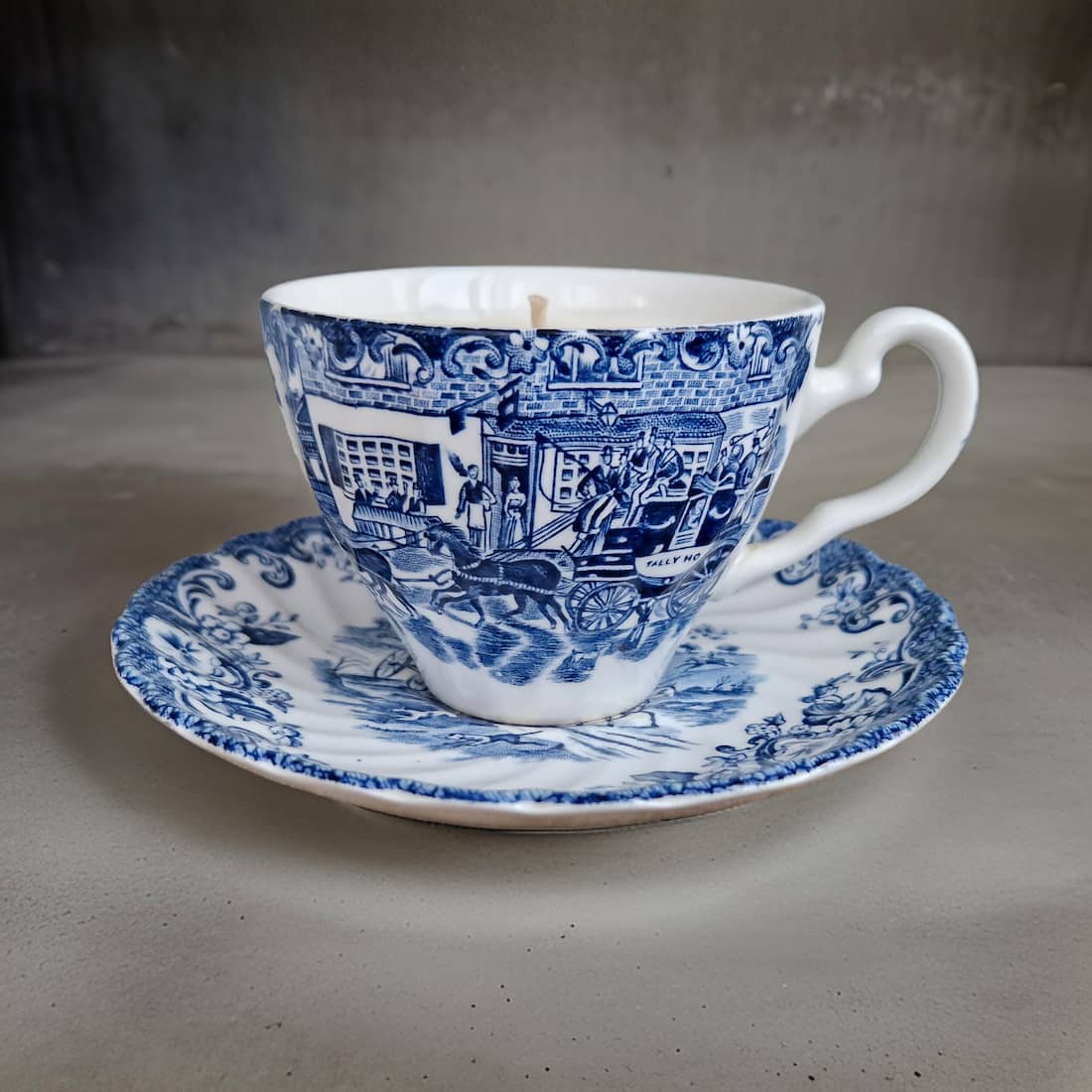 Blue and white teacup and saucer on a gray surface