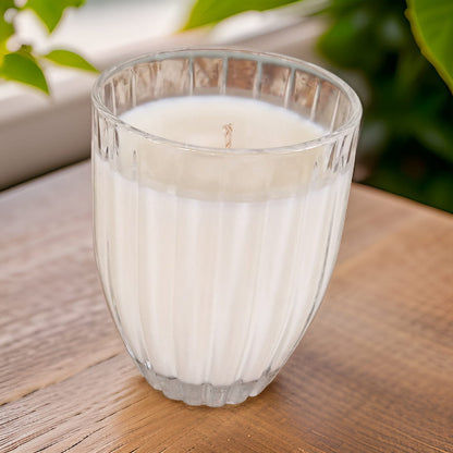 Glass of milk on a wooden surface with a blurred natural background