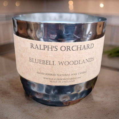 Candle labeled 'Ralph's Orchard Bluebell Woodlands' on a neutral background
