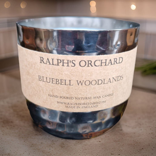 Candle labeled 'Ralph's Orchard Bluebell Woodlands' on a neutral background