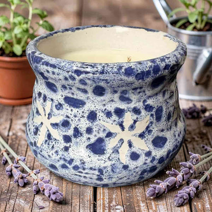 Blue and white ceramic pot with floral patterns on a wooden surface with lavender.