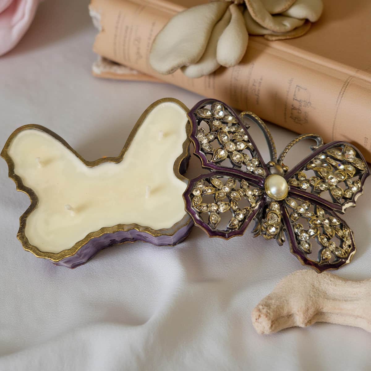 Butterfly-shaped object with decorative embellishments on a soft surface