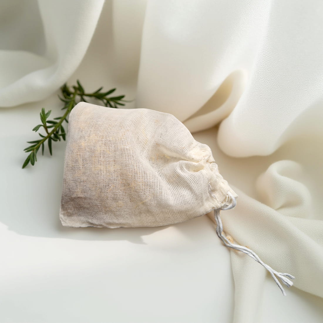Drawstring bag with greenery on a white fabric background