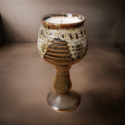 Ceramic goblet with textured surface on a plain background