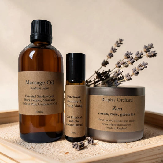 Massage oil, roller bottle, and candle with lavender on a wooden surface