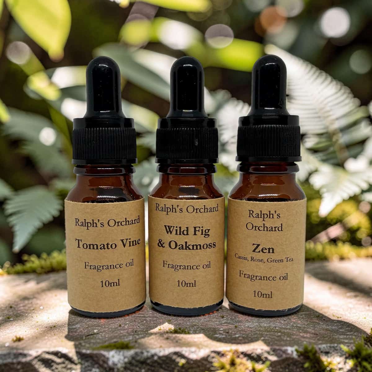 Three bottles of Ralph's Orchard fragrance oils on a natural background