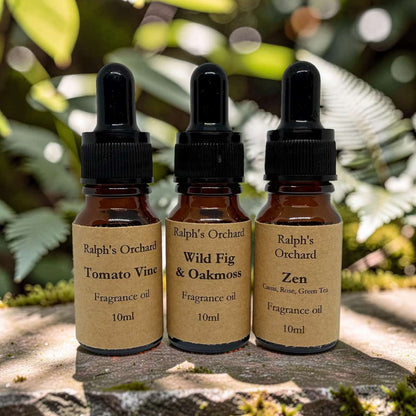Three bottles of Ralph's Orchard fragrance oils on a natural background