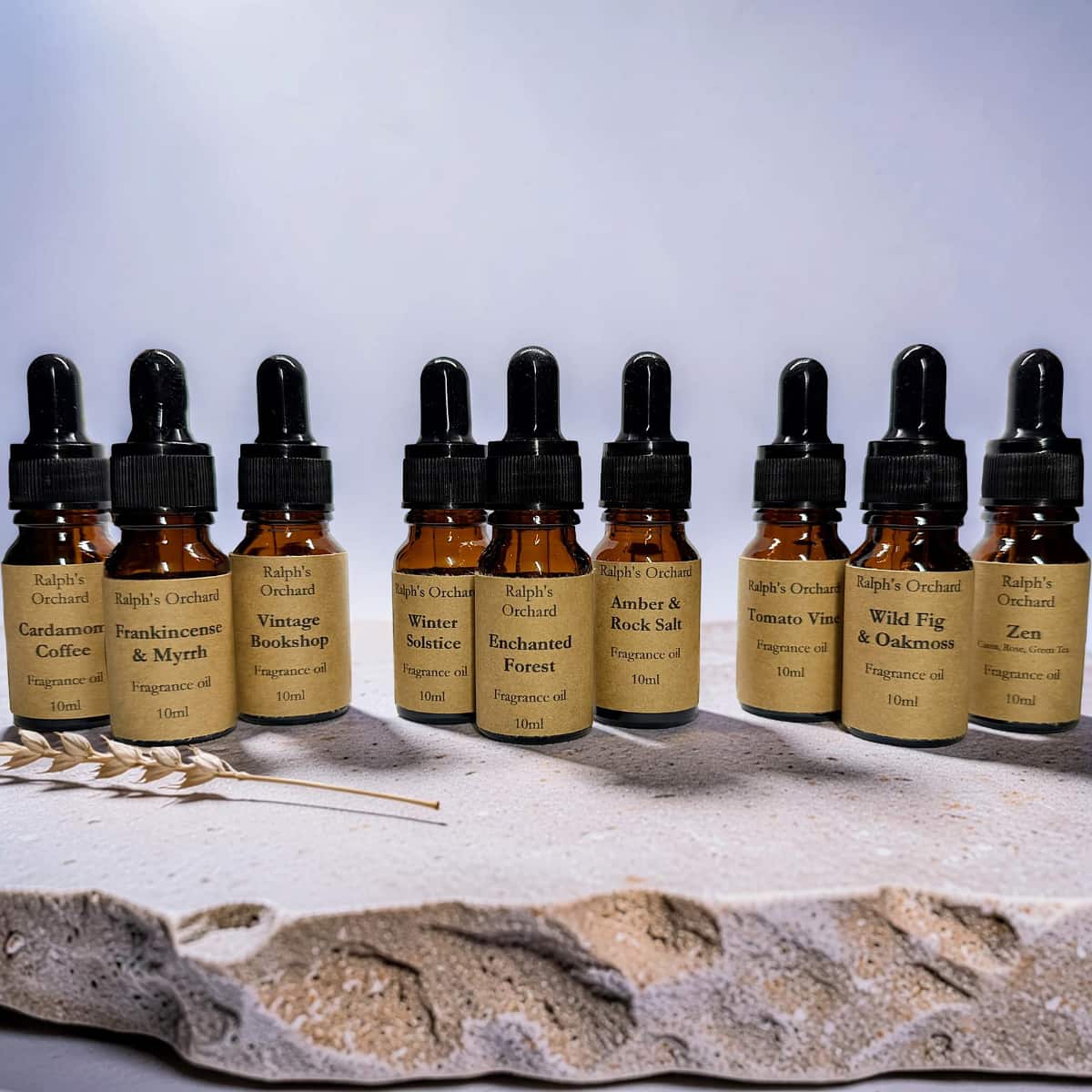Row of small bottles with droppers on a textured surface