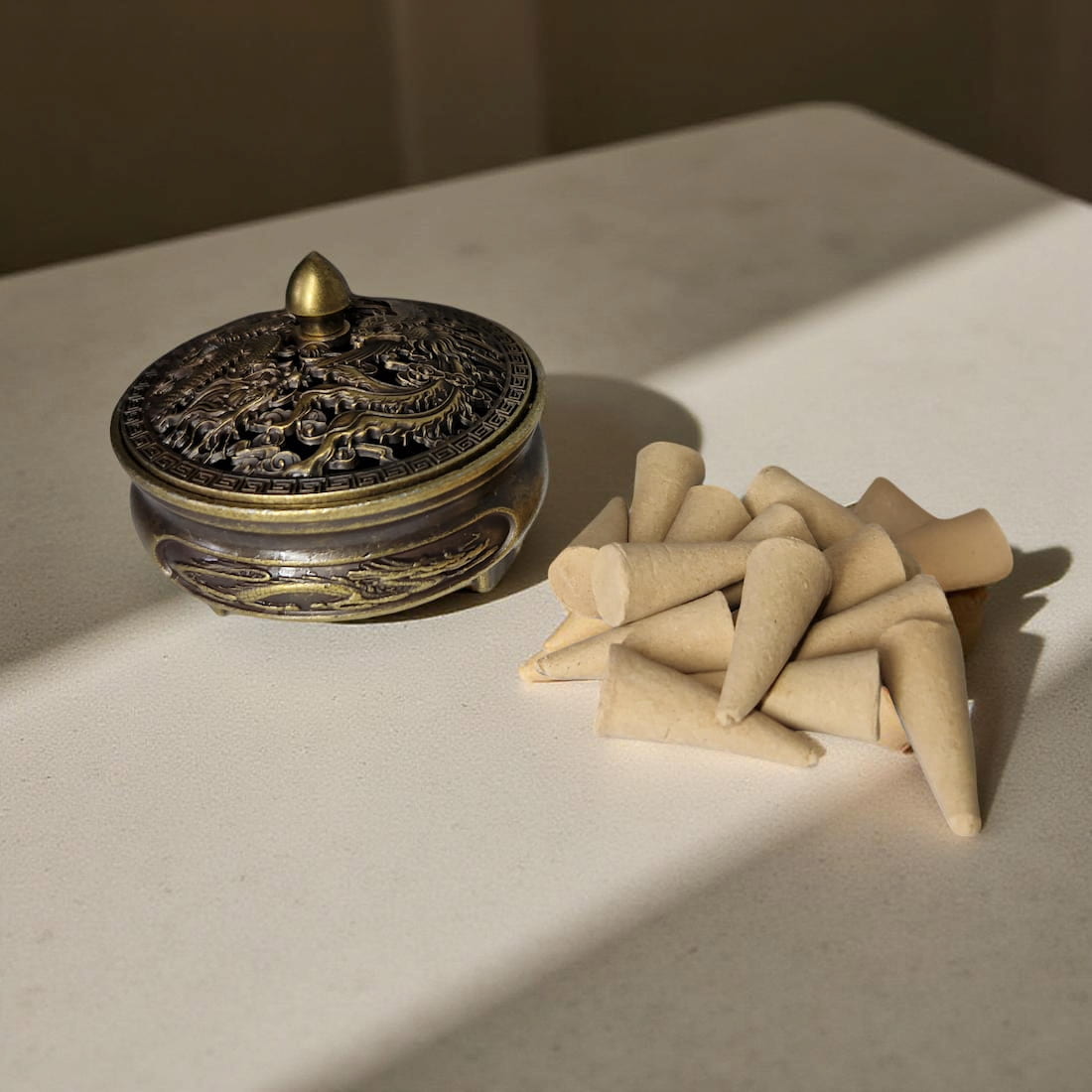 Decorative incense holder with cones on a light surface