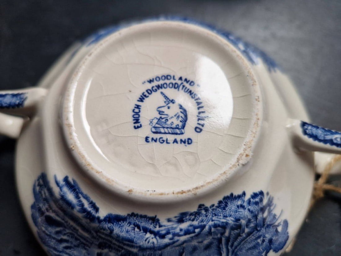 Close-up of a Wedgwood ceramic item with 'Woodland & Sons' branding.