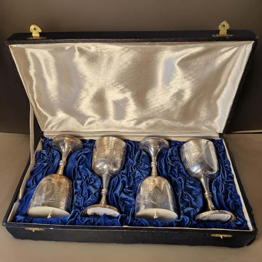 Set of four silver goblets in a black case with blue lining