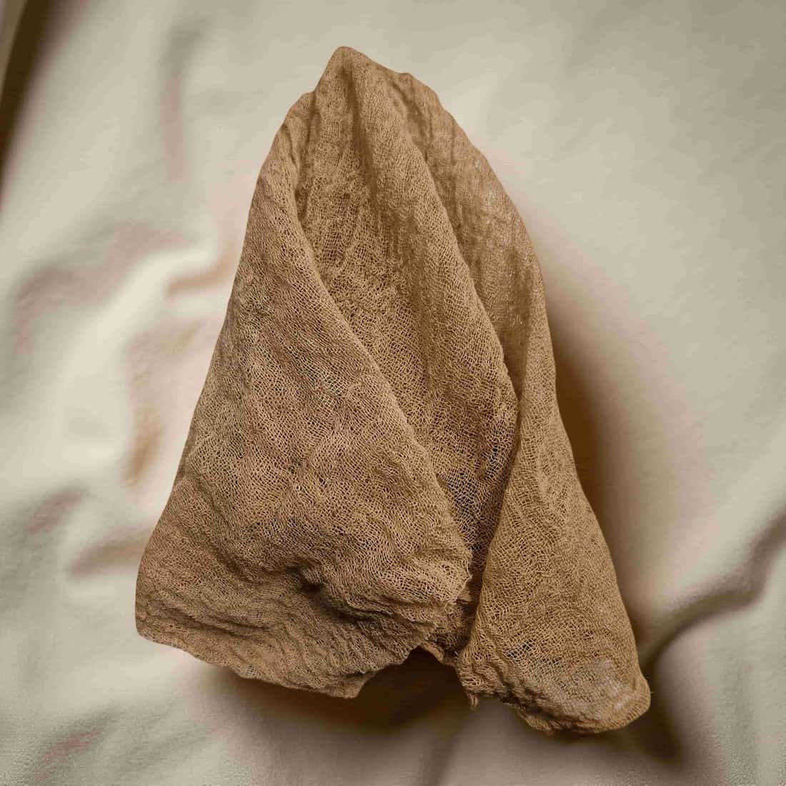 Brown textured gauze on a beige surface