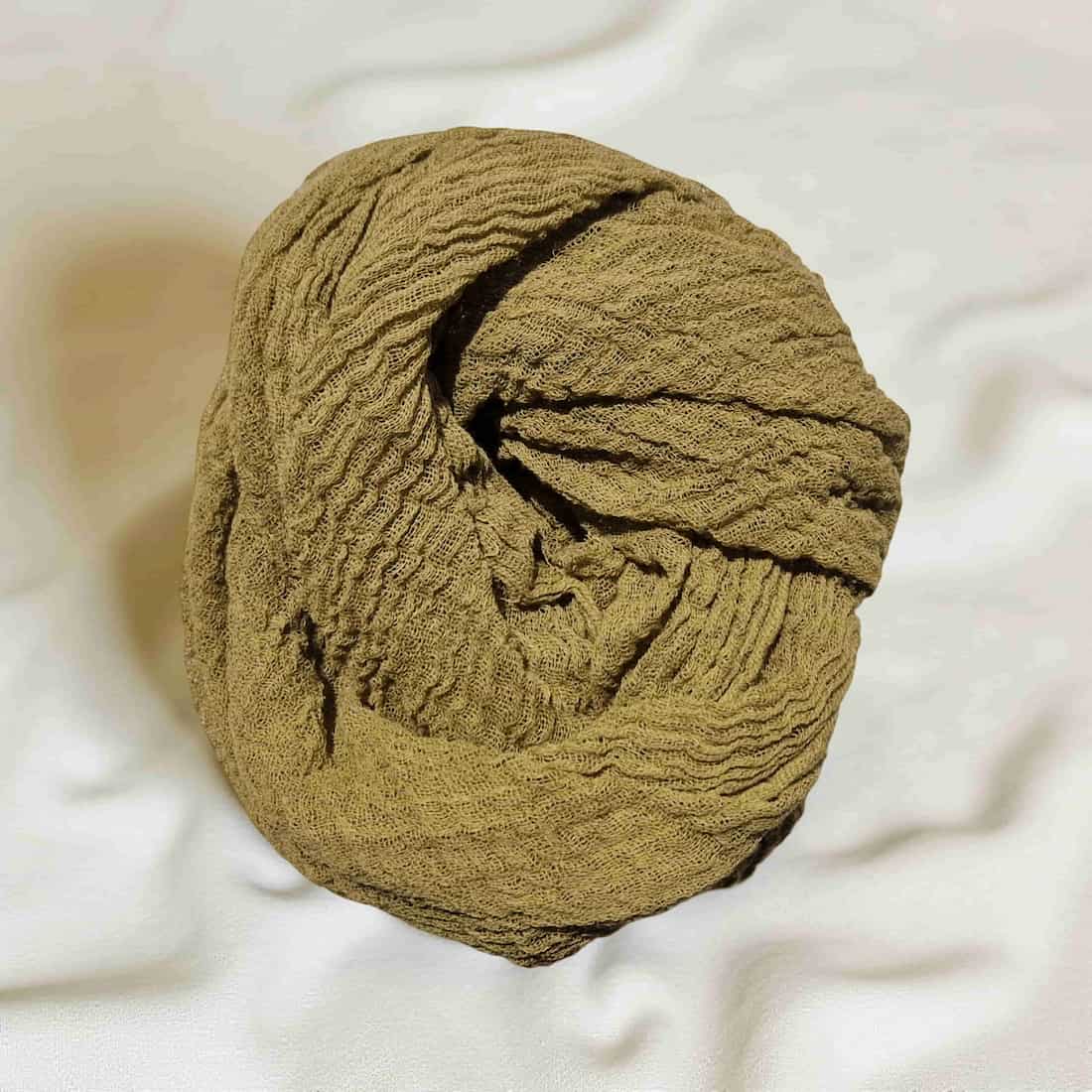 Ball of brown gauze on a white background
