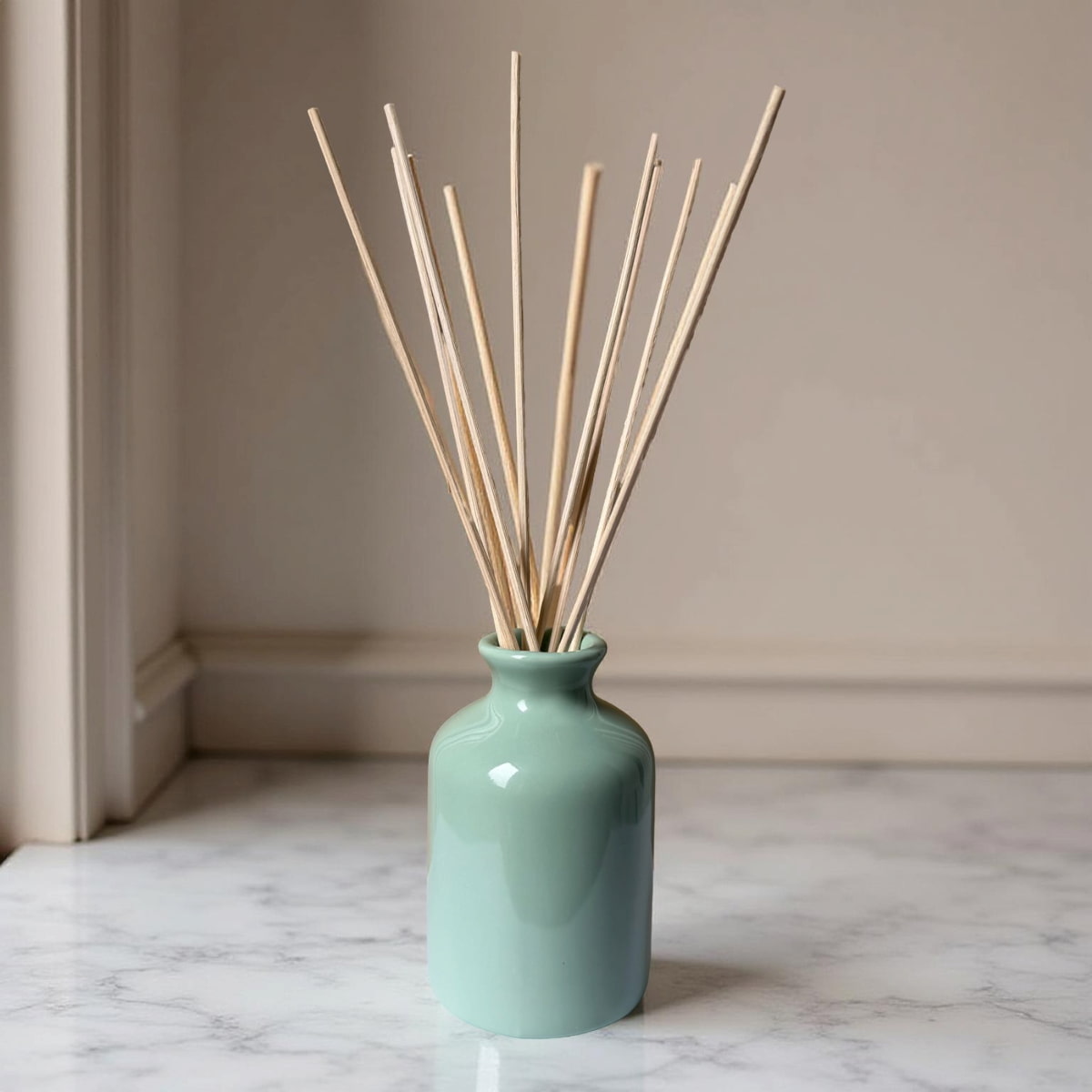 soft green ceramic diffuser bottle with pale reeds
