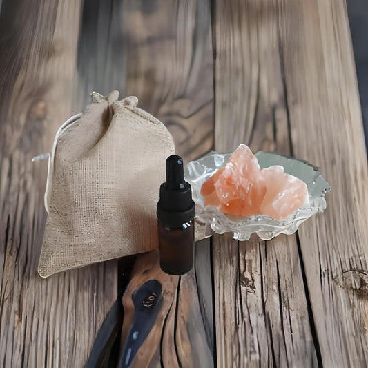 Bottle with dropper, drawstring bag, and crystal on a wooden surface
