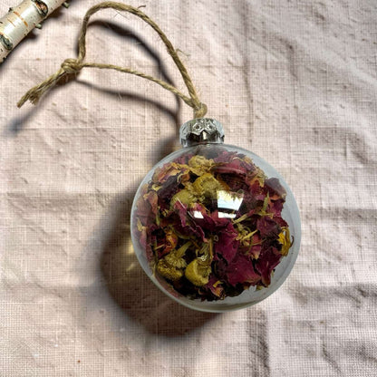 Clear bauble filled with dried rose petals, calendula and chamomile flowers