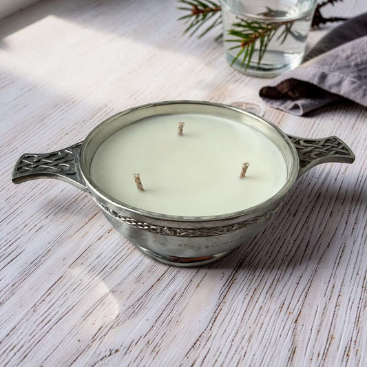 Decorative candle in a metal holder on a wooden surface