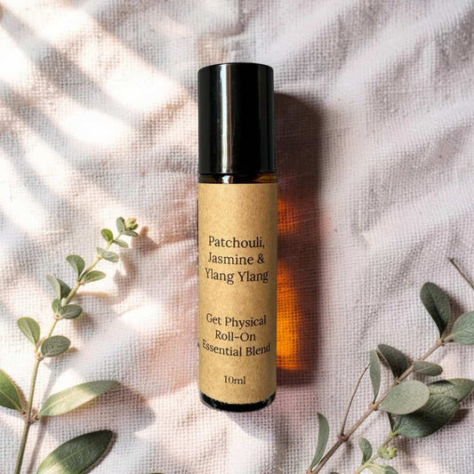 Roll-on essential oil blend bottle with botanicals on a textured fabric background