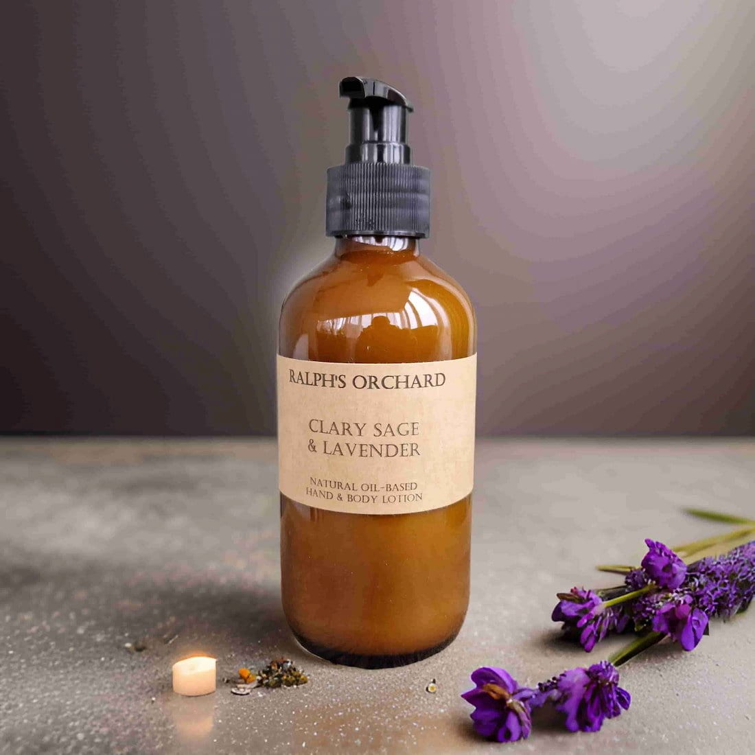 Bottle of Ralph's Orchard Clary Sage & Lavender product on a textured surface with lavender flowers.