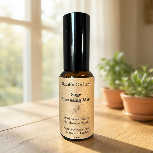 Bottle of Ralph's Orchard Sage Cleansing Mist on a wooden surface with plants in the background