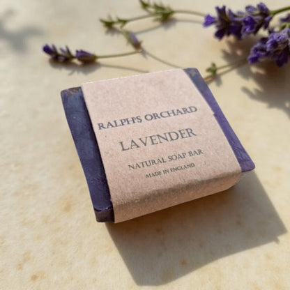 Ralph's Orchard Lavender natural soap bar on a light surface with lavender flowers.
