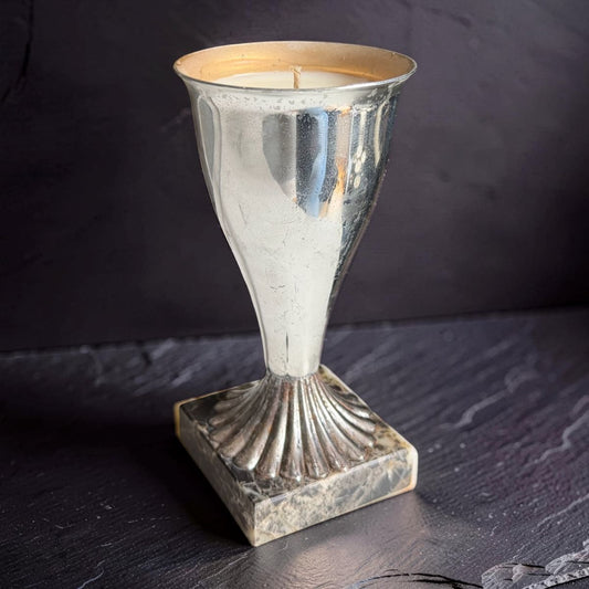Decorative silver candle holder on a dark surface